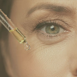 Oils application on the cheek of a woman.