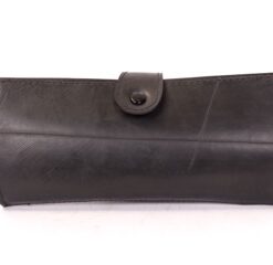 Women's wallet made of recycled tire products. Separate interior spaces for card, bills. Snap fastener.
