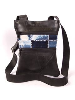 Recycled tire bag with fabric accents dyed with natural indigo. Two zipped exterior pockets and two interior zipped pockets.